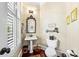 Charming powder room featuring hardwood floors, pedestal sink, and natural light at 2444 Darts Cove Way, Mount Pleasant, SC 29466