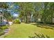 Large backyard featuring lush landscaping and mature trees at 248 Forest Trail, Isle of Palms, SC 29451