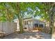 A spacious backyard with a gray brick house, outdoor shower and green trees creating a relaxing outdoor space at 248 Forest Trail, Isle of Palms, SC 29451