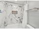 Bathtub with marble tile surround, shower curtain, and a niche for toiletries at 248 Forest Trail, Isle of Palms, SC 29451
