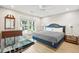 Bedroom featuring a king-size bed, bedside tables, and a large window overlooking the yard at 248 Forest Trail, Isle of Palms, SC 29451