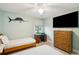 Bedroom with twin beds, a mounted TV, desk, and ample natural light at 248 Forest Trail, Isle of Palms, SC 29451