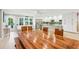 Bright dining area featuring a large wooden table with a bench, a modern kitchen with stainless steel appliances, and outdoor access at 248 Forest Trail, Isle of Palms, SC 29451