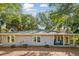 Charming coastal home featuring a shake shingle exterior, inviting front porch, and lovely mature landscaping at 248 Forest Trail, Isle of Palms, SC 29451