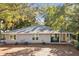 Charming single-story home with a green front lawn, inviting porch and beautiful trees providing curb appeal at 248 Forest Trail, Isle of Palms, SC 29451