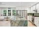 Bright kitchen with white cabinets, stainless appliances, and a large green marble island at 248 Forest Trail, Isle of Palms, SC 29451