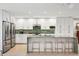 Bright kitchen with white cabinets, stainless appliances, and a large green marble island at 248 Forest Trail, Isle of Palms, SC 29451