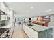 Open kitchen with a green marble island that looks into a spacious living and dining area at 248 Forest Trail, Isle of Palms, SC 29451