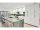 Kitchen featuring white cabinets, stainless appliances and a large green marble island with seating at 248 Forest Trail, Isle of Palms, SC 29451