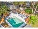 Aerial view of a backyard oasis with a pool, green foliage, lounge chairs and an outdoor dining set at 248 Forest Trail, Isle of Palms, SC 29451