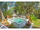 Inviting in-ground pool with stone patio, surrounded by tropical landscaping and comfortable lounging areas at 248 Forest Trail, Isle of Palms, SC 29451