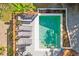 Aerial view of sparkling pool with sun loungers, lush landscaping, and adjacent outdoor lounge area at 248 Forest Trail, Isle of Palms, SC 29451