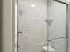Modern shower with glass enclosure, marble tile, and built-in niche for toiletries at 248 Forest Trail, Isle of Palms, SC 29451