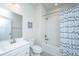 Bright bathroom featuring a white vanity, a toilet, and a shower-tub combination with blue wave-patterned curtain at 249 Oak View Way, Summerville, SC 29483