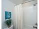 Clean bathroom featuring a bathtub with white tiles and shower, a toilet, and a calming wall art at 249 Oak View Way, Summerville, SC 29483