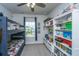 bedroom featuring bunk beds, toy shelves, storage, ceiling fan, and a window overlooking the neighborhood at 249 Oak View Way, Summerville, SC 29483