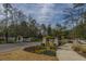 Picturesque entrance to The Ponds, showcasing brick pillars, white fencing, and lush landscaping at 249 Oak View Way, Summerville, SC 29483