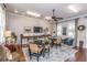 Inviting dining area with ample seating, decorative rug, and natural light streaming through large windows at 249 Oak View Way, Summerville, SC 29483