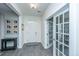 Welcoming entryway with light gray vinyl floors, white trim, and a charming gallery wall of Gathering photos at 249 Oak View Way, Summerville, SC 29483