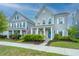 Charming two-story home with gray siding, white trim, landscaped yard, and a welcoming blue front door at 249 Oak View Way, Summerville, SC 29483