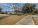 Elegant two-story home with a inviting front porch, landscaped yard, and a serene pathway leading to the entrance at 249 Oak View Way, Summerville, SC 29483