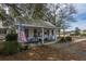 Charming home with a cozy porch, adorned with the American flag, and surrounded by mature trees at 249 Oak View Way, Summerville, SC 29483