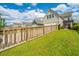 Well-maintained house featuring a green lawn, wood fence and a charming black pergola at 249 Oak View Way, Summerville, SC 29483