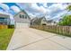 Charming gray home showcasing a spacious driveway, complemented by a well-maintained lawn and inviting curb appeal at 249 Oak View Way, Summerville, SC 29483