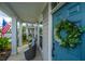 Inviting front porch with a blue door adorned with a wreath, and cozy seating area at 249 Oak View Way, Summerville, SC 29483
