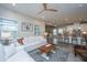 Open-concept living room with white sofa, wood floors, and view of adjacent kitchen at 249 Oak View Way, Summerville, SC 29483