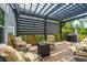 Relaxing outdoor patio with comfortable seating, a fire pit, and a stylish pergola for shade at 249 Oak View Way, Summerville, SC 29483