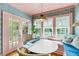 Cozy dining room featuring a round table, colorful wallpaper, bench seating, and French doors at 27 Stocker Dr, Charleston, SC 29407
