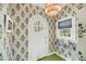 Foyer features patterned wallpaper, green floor tile and arched front door at 27 Stocker Dr, Charleston, SC 29407