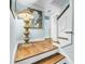 Hallway with hardwood floors, white trim, a decorative lamp and a mirror on the wall at 27 Stocker Dr, Charleston, SC 29407