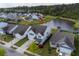 Aerial view of a lovely home, well-manicured lawn, mature trees, and scenic pond in a desirable neighborhood at 2840 Conservancy Ln, Charleston, SC 29414