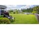 Beautiful backyard featuring a well-manicured lawn and tranquil pond views from the screened porch at 2840 Conservancy Ln, Charleston, SC 29414