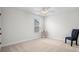 Clean and simple bedroom with neutral carpet, a chair, and bright natural light at 2840 Conservancy Ln, Charleston, SC 29414