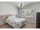 Bright bedroom featuring a decorative bed frame, chandelier, and a sunlit window at 2840 Conservancy Ln, Charleston, SC 29414