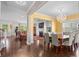 Formal dining room showcasing elegant chandelier and hardwood floors, open to living room at 2840 Conservancy Ln, Charleston, SC 29414