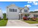 Charming two-story home with attached garage, manicured lawn, and colorful landscaping at 2840 Conservancy Ln, Charleston, SC 29414
