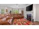 Spacious living room featuring a fireplace, large TV, and comfortable leather seating at 2840 Conservancy Ln, Charleston, SC 29414