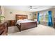 Spacious main bedroom features a ceiling fan, neutral walls, large window, and beautiful furnishings at 2840 Conservancy Ln, Charleston, SC 29414