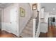 Inviting staircase with decorative wrought iron spindles and wooden handrail to the upper level at 2840 Conservancy Ln, Charleston, SC 29414
