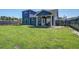 View of the home's backyard, showcasing the covered patio, green lawn, and wooden fencing at 2880 Cavalcade Cir, Johns Island, SC 29455