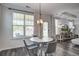 Dining area filled with natural light with a modern chandelier and an open-concept layout at 2880 Cavalcade Cir, Johns Island, SC 29455