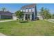 Charming two-story home featuring a blue exterior, well-kept lawn, and attached garage at 2880 Cavalcade Cir, Johns Island, SC 29455