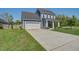 Charming two-story home with well-maintained lawn and a long driveway leading to the attached two-car garage at 2880 Cavalcade Cir, Johns Island, SC 29455