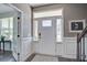 Bright foyer with a decorative rug, complemented by beautiful hardwood floors and staircase at 2880 Cavalcade Cir, Johns Island, SC 29455