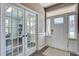 Elegant foyer with hardwood floors, french doors, and natural light creating a welcoming entrance at 2880 Cavalcade Cir, Johns Island, SC 29455