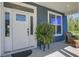 Inviting front porch features a cozy sitting area and a well-decorated front door with a side window at 2880 Cavalcade Cir, Johns Island, SC 29455
